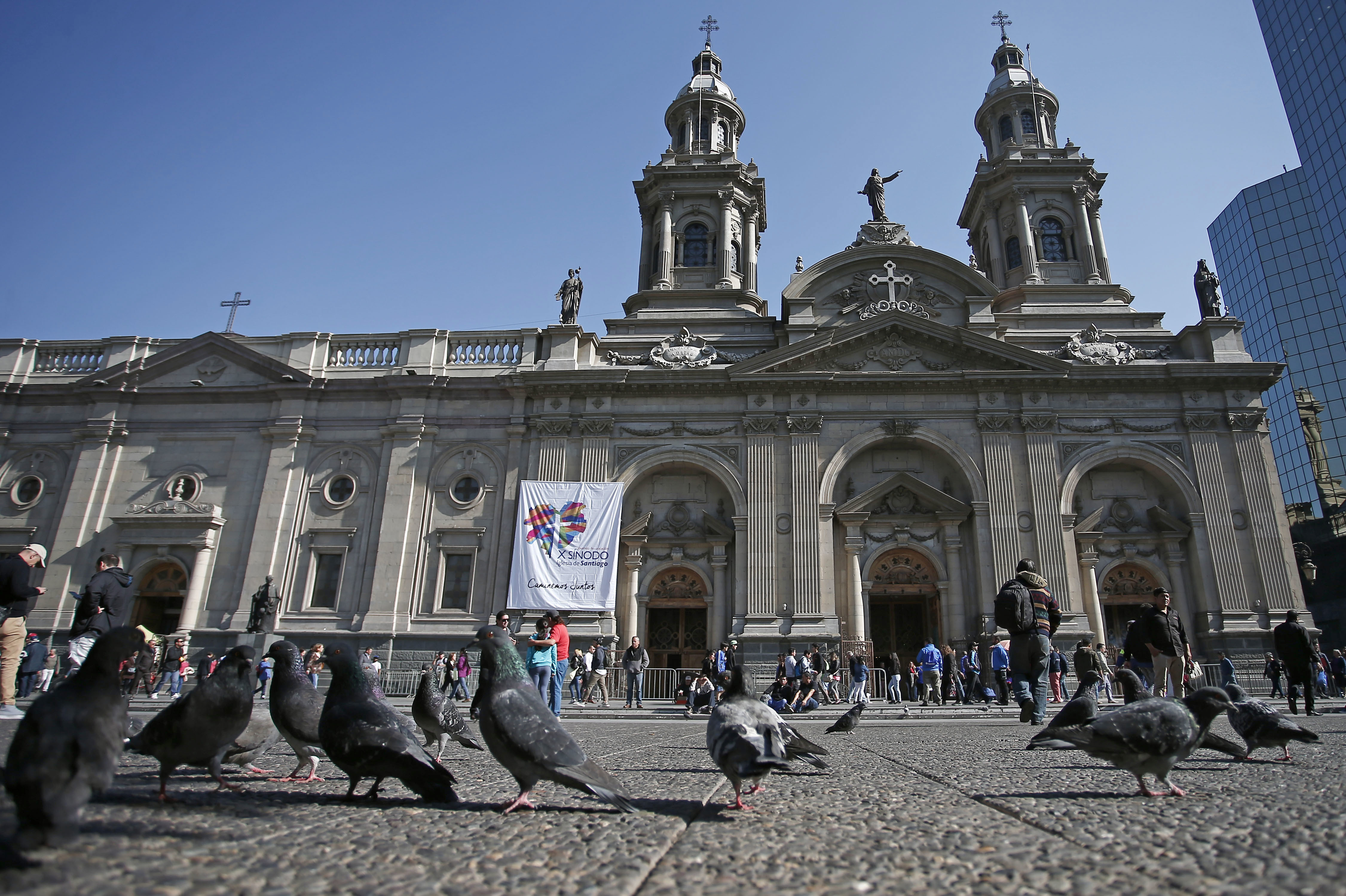 FILE - In this May 18, 2018 file photo, pigeons are fed in front of the Santiago Cathedral, in Santiago, Chile. Pope Francis' high-stakes sex abuse prevention summit is meant to call attention to the crisis as a global problem that requires a global response. Francis discovered first-hand just how pervasive clerical sex abuse is — and how effectively it has been covered up by the Catholic hierarchy — when in January 2018 he branded as FILE - In this May 18, 2018 file photo, pigeons are fed in front of the Santiago Cathedral, in Santiago, Chile. Pope Francis' high-stakes sex abuse prevention summit is meant to call attention to the crisis as a global problem that requires a global response. Francis discovered first-hand just how pervasive clerical sex abuse is — and how effectively it has been covered up by the Catholic hierarchy — when in January 2018 he branded as
