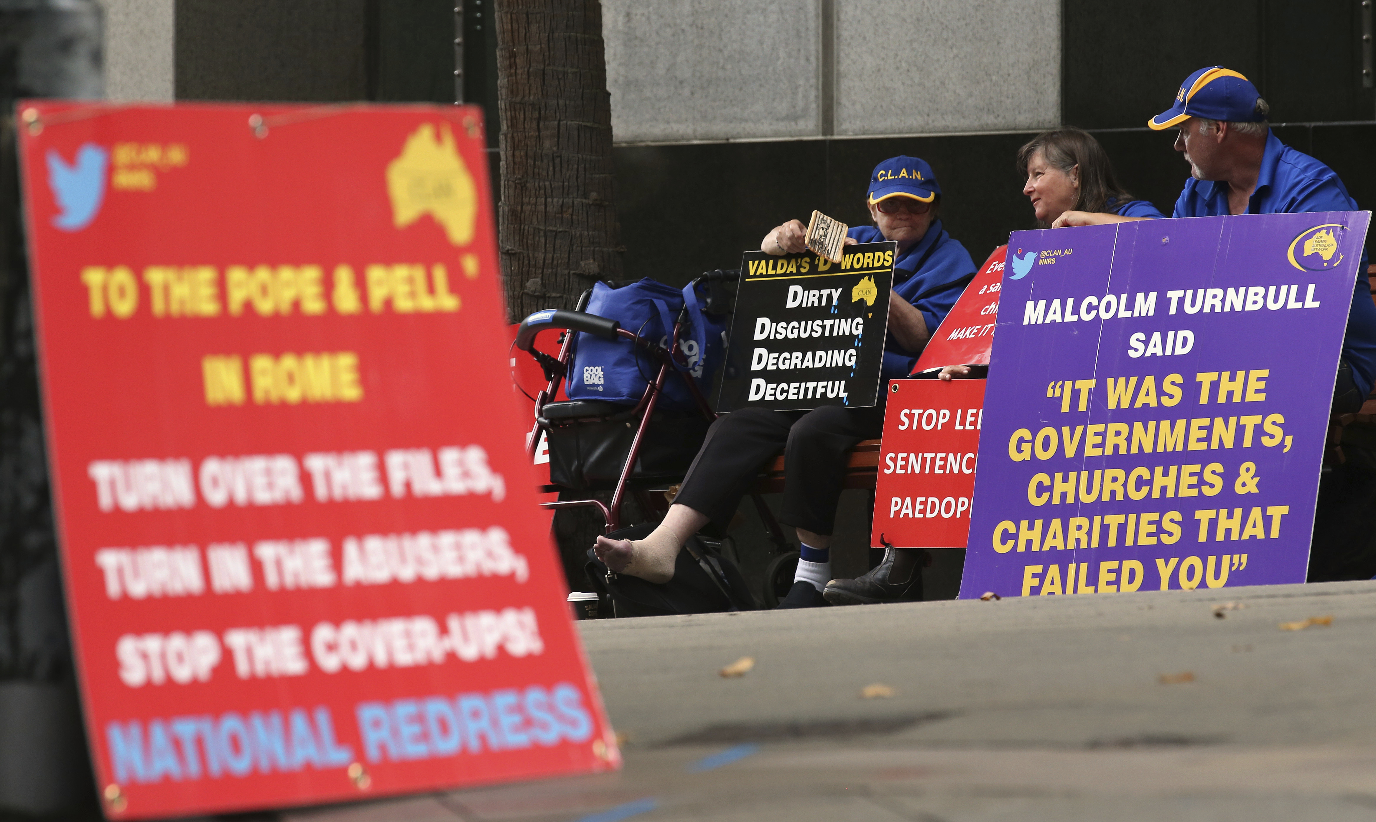 FILE - In this March 1, 2016 file photo, a group gathers to protest with placards outside an inquiry into child sex abuse in Sydney. Pope Francis' high-stakes sex abuse prevention summit is meant to call attention to the crisis as a global problem that requires a global response. Australia's Catholic Church has a horrific abuse record, which in part prompted the government to launch a four-year national investigation into all forms of institutional abuse — Catholic and otherwise. (AP Photo/Rick Rycroft, file) FILE - In this March 1, 2016 file photo, a group gathers to protest with placards outside an inquiry into child sex abuse in Sydney. Pope Francis' high-stakes sex abuse prevention summit is meant to call attention to the crisis as a global problem that requires a global response. Australia's Catholic Church has a horrific abuse record, which in part prompted the government to launch a four-year national investigation into all forms of institutional abuse — Catholic and otherwise. (AP Photo/Rick Rycroft, file)