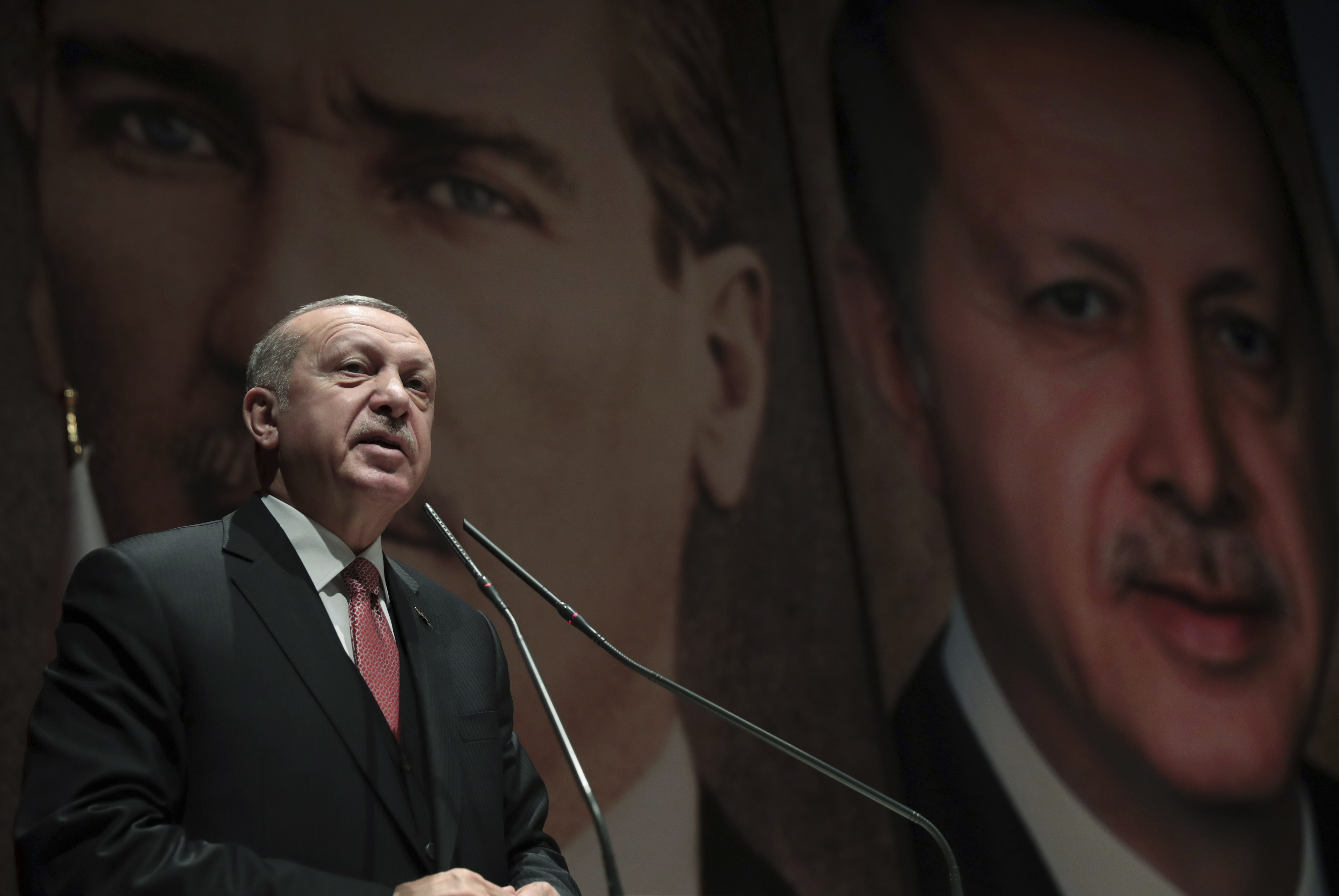 Backdropped by a picture of modern Turkey's founder Mustafa Kemal Ataturk, back left, Turkey's President Recep Tayyip Erdogan, with his image right, talk to his ruling Justice and Development Party (AKP) provincial leadership members in Ankara, Turkey, Tuesday, Jan. 29, 2019. (Presidential Press Service via AP, Pool) Backdropped by a picture of modern Turkey's founder Mustafa Kemal Ataturk, back left, Turkey's President Recep Tayyip Erdogan, with his image right, talk to his ruling Justice and Development Party (AKP) provincial leadership members in Ankara, Turkey, Tuesday, Jan. 29, 2019. (Presidential Press Service via AP, Pool)