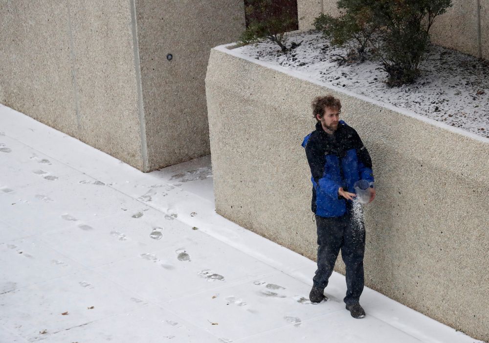 Employee Dustin Zoglman throws salt on a slippery walkway in front of the Red Lion Hotel Paper Valley Wednesday, Nov. 13, 2019, in Appleton, Wis. (Dan Powers/The Post-Crescent via AP) Employee Dustin Zoglman throws salt on a slippery walkway in front of the Red Lion Hotel Paper Valley Wednesday, Nov. 13, 2019, in Appleton, Wis. (Dan Powers/The Post-Crescent via AP)
