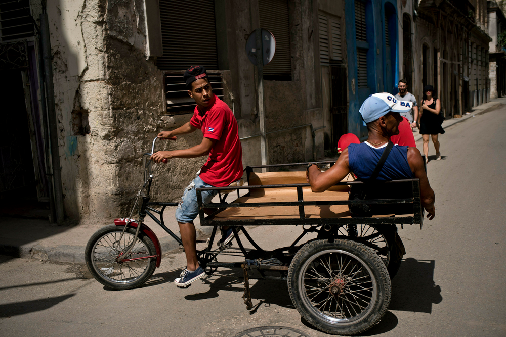 A man pedaling a tricycle equipped with a platform earns a living by transporting passengers through Havana, Cuba, Wednesday, April 10, 2019. Communist Party leader Raúl Castro warned Cubans on Wednesday that they should brace for worsening shortages due to Trump administration policies, but said the island won't return to the extreme deprivation of the post-Soviet period. (AP Photo/Ramon Espinosa) A man pedaling a tricycle equipped with a platform earns a living by transporting passengers through Havana, Cuba, Wednesday, April 10, 2019. Communist Party leader Raúl Castro warned Cubans on Wednesday that they should brace for worsening shortages due to Trump administration policies, but said the island won't return to the extreme deprivation of the post-Soviet period. (AP Photo/Ramon Espinosa)
