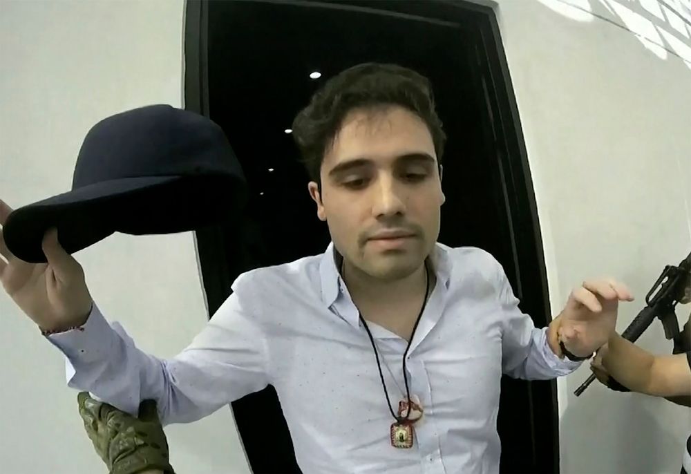 This Oct. 17, 2019 frame grab from video provided by the Mexican government shows Ovidio Guzman Lopez at the moment of his detention, in Culiacan, Mexico. Mexican security forces had Ovidio Guzman Lopez, a son of Joaquin This Oct. 17, 2019 frame grab from video provided by the Mexican government shows Ovidio Guzman Lopez at the moment of his detention, in Culiacan, Mexico. Mexican security forces had Ovidio Guzman Lopez, a son of Joaquin
