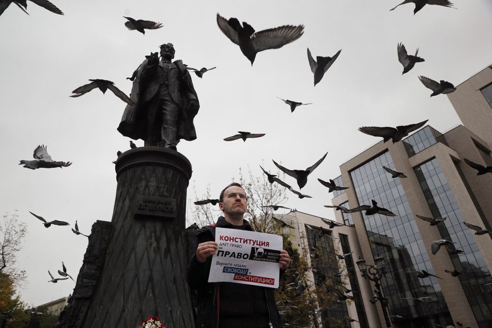 An opposition activist holds a poster reading An opposition activist holds a poster reading