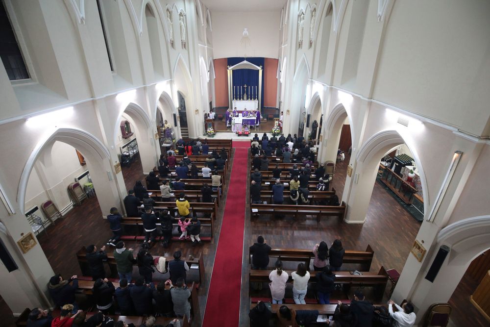 Worshippers pray during a Mass and vigil for the 39 victims found dead inside the back of a truck in Grays, Essex, at The Holy Name and Our Lady of the Sacred Heart Church, east London's Vietnamese church on Saturday, Nov. 2, 2019. All those killed were Vietnamese nationals, British police said. (Yui Mok/PA via AP) Worshippers pray during a Mass and vigil for the 39 victims found dead inside the back of a truck in Grays, Essex, at The Holy Name and Our Lady of the Sacred Heart Church, east London's Vietnamese church on Saturday, Nov. 2, 2019. All those killed were Vietnamese nationals, British police said. (Yui Mok/PA via AP)