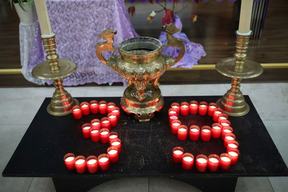 Candles are laid out as priest of the Vietnamese Catholic Cathedral in east London, Father Simon Thang Duc Nguyen speaks at The Holy Name and Our Lady of the Sacred Heart Church, London's Vietnamese church, in east London. Saturday Nov. 2, 2019, during a service and vigil to honor the 39 victims who died in a refrigerated truck container found on Oct. 23. The community is mourning the unidentified victims, who were trying to enter Britain in hopes of finding opportunity. (Yui Mok/PA via AP) Candles are laid out as priest of the Vietnamese Catholic Cathedral in east London, Father Simon Thang Duc Nguyen speaks at The Holy Name and Our Lady of the Sacred Heart Church, London's Vietnamese church, in east London. Saturday Nov. 2, 2019, during a service and vigil to honor the 39 victims who died in a refrigerated truck container found on Oct. 23. The community is mourning the unidentified victims, who were trying to enter Britain in hopes of finding opportunity. (Yui Mok/PA via AP)