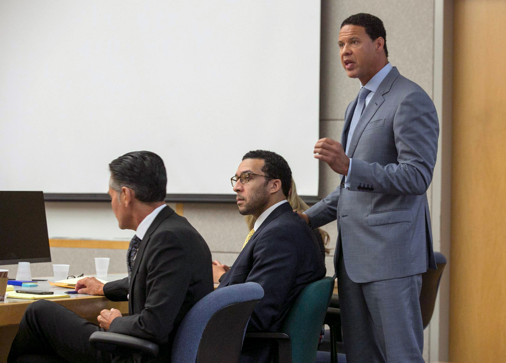 Brian Watkins, right, an attorney for former NFL football player Kellen Winslow Jr., puts his hands on Winslow as he gives his opening statement to the jury during Winslow's rape trial, Monday May 20, 2019, in Vista, Calif. (John Gibbins/The San Diego Union-Tribune via AP, Pool) Brian Watkins, right, an attorney for former NFL football player Kellen Winslow Jr., puts his hands on Winslow as he gives his opening statement to the jury during Winslow's rape trial, Monday May 20, 2019, in Vista, Calif. (John Gibbins/The San Diego Union-Tribune via AP, Pool)