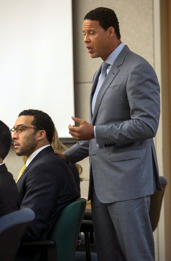 Brian Watkins, right, an attorney for former NFL football player Kellen Winslow Jr., puts his hands on Winslow as he gives his opening statement to the jury during Winslow's rape trial, Monday May 20, 2019, in Vista, Calif. (John Gibbins/The San Diego Union-Tribune via AP, Pool) Brian Watkins, right, an attorney for former NFL football player Kellen Winslow Jr., puts his hands on Winslow as he gives his opening statement to the jury during Winslow's rape trial, Monday May 20, 2019, in Vista, Calif. (John Gibbins/The San Diego Union-Tribune via AP, Pool)