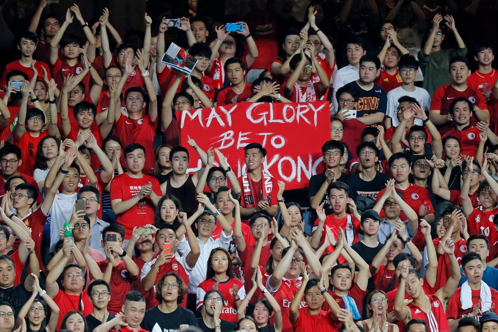 Hong Kong soccer fans sing during the FIFA World Cup Qatar 2022 and AFC Asian Cup 2023 Preliminary Joint Qualification Round 2 soccer match between Hong Kong and Iran, in Hong Kong, Tuesday, Sept. 10, 2019. The crowd broke out into Hong Kong soccer fans sing during the FIFA World Cup Qatar 2022 and AFC Asian Cup 2023 Preliminary Joint Qualification Round 2 soccer match between Hong Kong and Iran, in Hong Kong, Tuesday, Sept. 10, 2019. The crowd broke out into