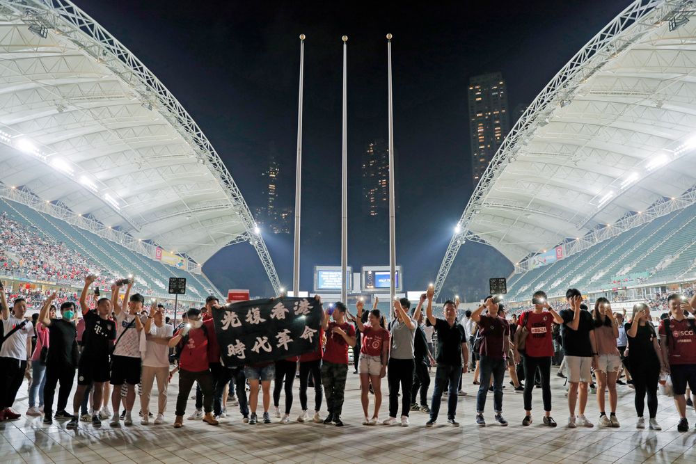Hong Kong soccer fans form human chain and chant banner reads Hong Kong soccer fans form human chain and chant banner reads