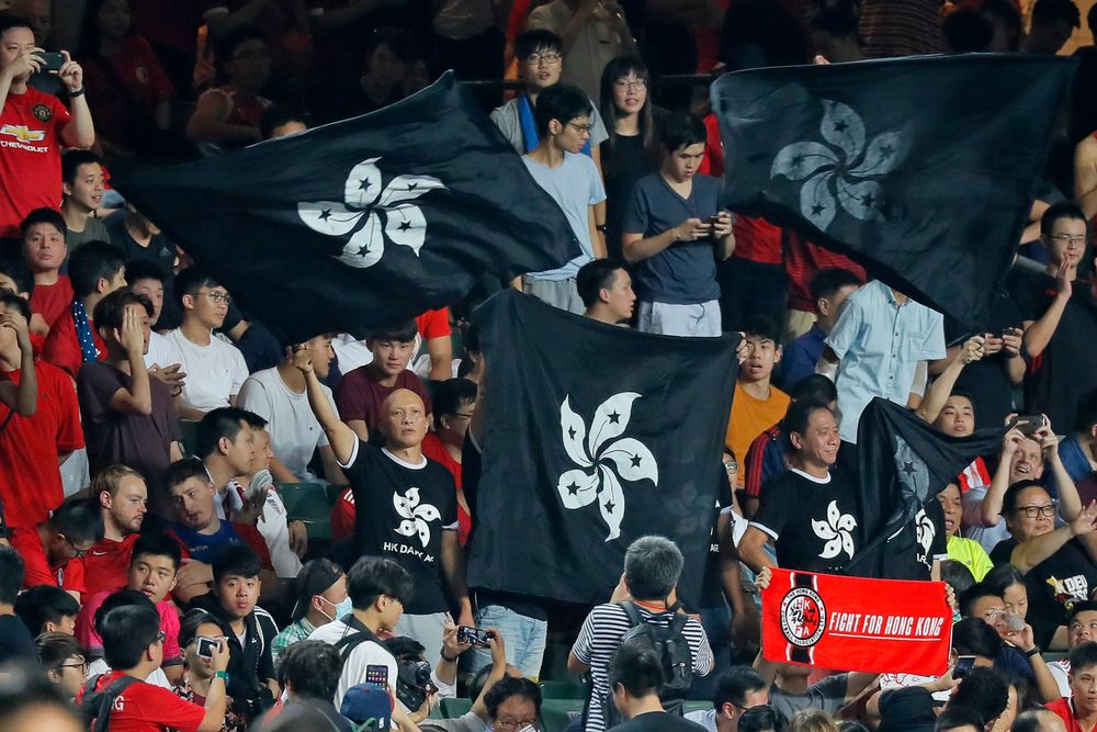 Hong Kong soccer fans wave black version of the Hong Kong flags to protest against government during the FIFA World Cup Qatar 2022 and AFC Asian Cup 2023 Preliminary Joint Qualification Round 2 soccer match between Hong Kong and Iran, in Hong Kong, Tuesday, Sept. 10, 2019. The crowd broke out into Hong Kong soccer fans wave black version of the Hong Kong flags to protest against government during the FIFA World Cup Qatar 2022 and AFC Asian Cup 2023 Preliminary Joint Qualification Round 2 soccer match between Hong Kong and Iran, in Hong Kong, Tuesday, Sept. 10, 2019. The crowd broke out into