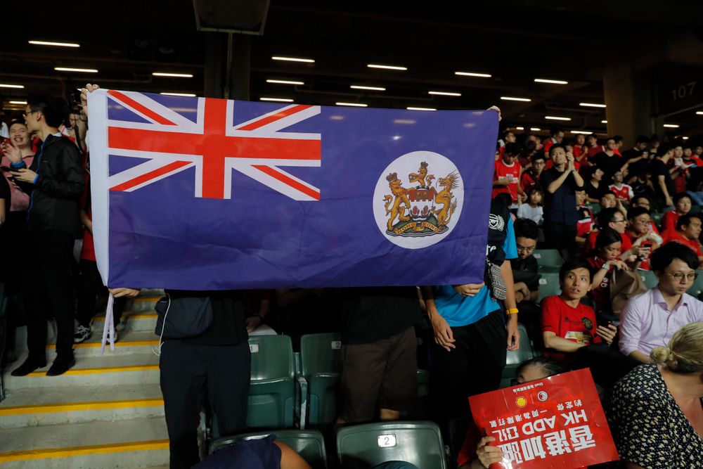 Hong Kong soccer fans hold a colonial era flag of Hong Kong during the FIFA World Cup Qatar 2022 and AFC Asian Cup 2023 Preliminary Joint Qualification Round 2 soccer match between Hong Kong and Iran, in Hong Kong, Tuesday, Sept. 10, 2019. The crowd broke out into Hong Kong soccer fans hold a colonial era flag of Hong Kong during the FIFA World Cup Qatar 2022 and AFC Asian Cup 2023 Preliminary Joint Qualification Round 2 soccer match between Hong Kong and Iran, in Hong Kong, Tuesday, Sept. 10, 2019. The crowd broke out into