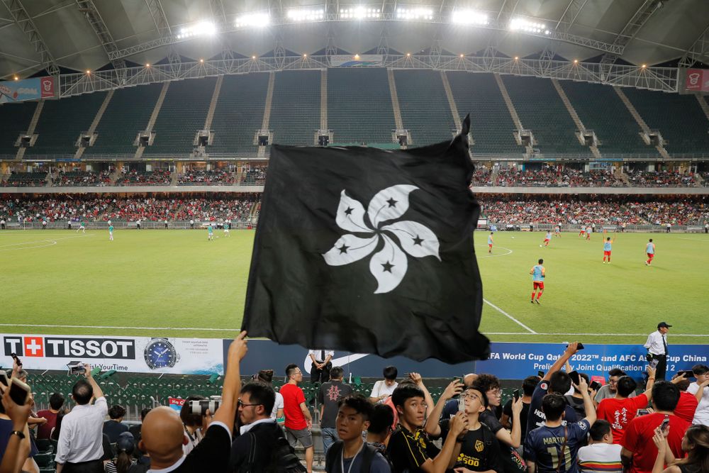 Hong Kong soccer fans waves a black version of the Hong Kong flag to protest against government during the FIFA World Cup Qatar 2022 and AFC Asian Cup 2023 Preliminary Joint Qualification Round 2 soccer match between Hong Kong and Iran, in Hong Kong, Tuesday, Sept. 10, 2019. The crowd broke out into Hong Kong soccer fans waves a black version of the Hong Kong flag to protest against government during the FIFA World Cup Qatar 2022 and AFC Asian Cup 2023 Preliminary Joint Qualification Round 2 soccer match between Hong Kong and Iran, in Hong Kong, Tuesday, Sept. 10, 2019. The crowd broke out into