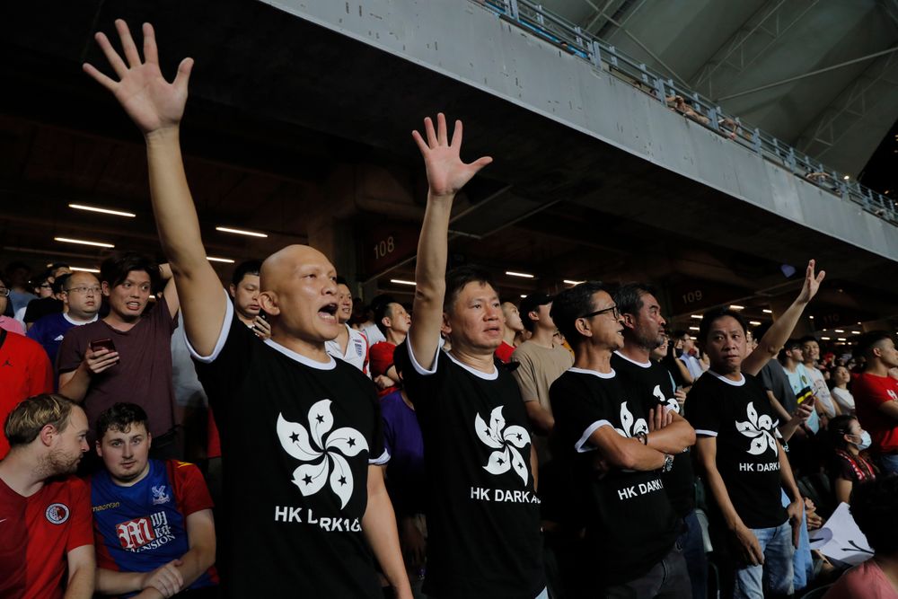 Hong Kong soccer fans wear T-shirt featuring black version of the Hong Kong flags to protest against government during the FIFA World Cup Qatar 2022 and AFC Asian Cup 2023 Preliminary Joint Qualification Round 2 soccer match between Hong Kong and Iran, in Hong Kong, Tuesday, Sept. 10, 2019. The crowd broke out into Hong Kong soccer fans wear T-shirt featuring black version of the Hong Kong flags to protest against government during the FIFA World Cup Qatar 2022 and AFC Asian Cup 2023 Preliminary Joint Qualification Round 2 soccer match between Hong Kong and Iran, in Hong Kong, Tuesday, Sept. 10, 2019. The crowd broke out into