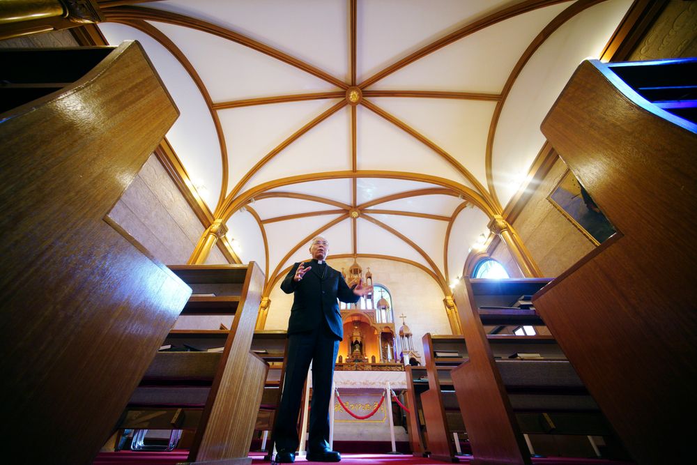 In this Nov. 16, 2019, photo, Japanese Archbishop Mitsuaki Takami, who heads Nagasaki's Catholic community of 60,000, the biggest in Japan, speaks in front of a statue of the Virgin Mary that was damaged in the A-bomb attack, at the Urakami Cathedral in Nagasaki, southern Japan. Pope Francis will start his first official visit to Japan in Nagasaki, ground zero for the Christian experience in a nation where the Catholic leader once dreamed of living as a missionary. (AP Photo/Eugene Hoshiko) In this Nov. 16, 2019, photo, Japanese Archbishop Mitsuaki Takami, who heads Nagasaki's Catholic community of 60,000, the biggest in Japan, speaks in front of a statue of the Virgin Mary that was damaged in the A-bomb attack, at the Urakami Cathedral in Nagasaki, southern Japan. Pope Francis will start his first official visit to Japan in Nagasaki, ground zero for the Christian experience in a nation where the Catholic leader once dreamed of living as a missionary. (AP Photo/Eugene Hoshiko)