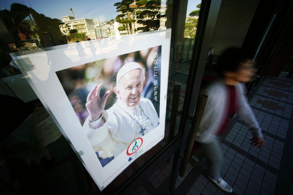 In this Nov. 16, 2019, photo, a woman walks by a poster of Pope Francis at the Urakami Cathedral in Nagasaki, southern Japan. Pope Francis will start his first official visit to Japan in Nagasaki, ground zero for the Christian experience in a nation where the Catholic leader once dreamed of living as a missionary. (AP Photo/Eugene Hoshiko) In this Nov. 16, 2019, photo, a woman walks by a poster of Pope Francis at the Urakami Cathedral in Nagasaki, southern Japan. Pope Francis will start his first official visit to Japan in Nagasaki, ground zero for the Christian experience in a nation where the Catholic leader once dreamed of living as a missionary. (AP Photo/Eugene Hoshiko)