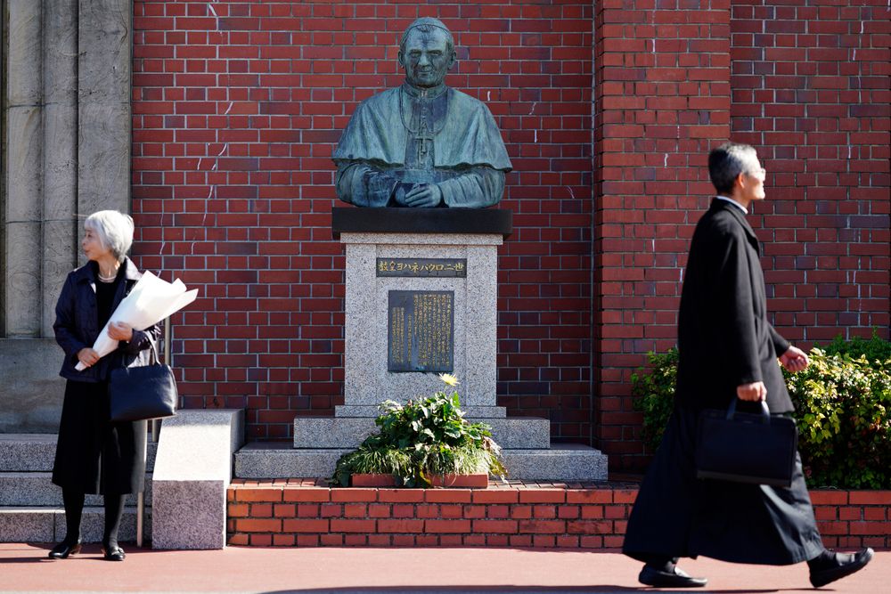 In this Nov. 16, 2019, photo, people walk past a statue of the late Pope John Paul II, who visited Nagasaki in 1981, at the Urakami Cathedral in Nagasaki, southern Japan. Pope Francis will start his first official visit to Japan in Nagasaki, ground zero for the Christian experience in a nation where the Catholic leader once dreamed of living as a missionary. (AP Photo/Eugene Hoshiko) In this Nov. 16, 2019, photo, people walk past a statue of the late Pope John Paul II, who visited Nagasaki in 1981, at the Urakami Cathedral in Nagasaki, southern Japan. Pope Francis will start his first official visit to Japan in Nagasaki, ground zero for the Christian experience in a nation where the Catholic leader once dreamed of living as a missionary. (AP Photo/Eugene Hoshiko)