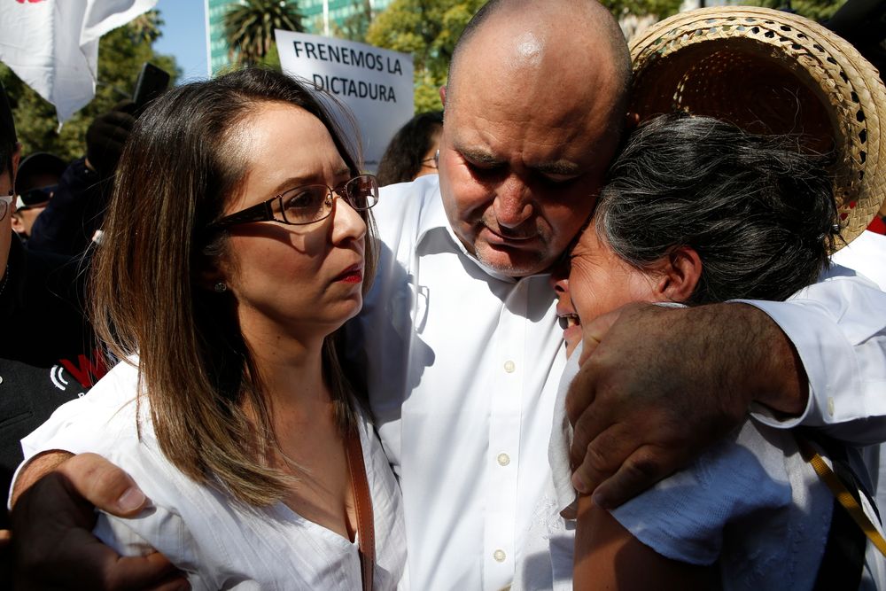Julian LeBaron, center, embraces Erika Garcia, left, and another woman before a protest against the first year in office of Mexico's President Andres Manuel Lopez Obrador, in Mexico City, Sunday, Dec. 1, 2019. LeBaron joined a protest on Reforma avenue, to expressed anger and frustration over increasingly appalling incidents of violence, a stagnant economy and deepening political divisions in the country. (AP Photo/Ginnette Riquelme) Julian LeBaron, center, embraces Erika Garcia, left, and another woman before a protest against the first year in office of Mexico's President Andres Manuel Lopez Obrador, in Mexico City, Sunday, Dec. 1, 2019. LeBaron joined a protest on Reforma avenue, to expressed anger and frustration over increasingly appalling incidents of violence, a stagnant economy and deepening political divisions in the country. (AP Photo/Ginnette Riquelme)