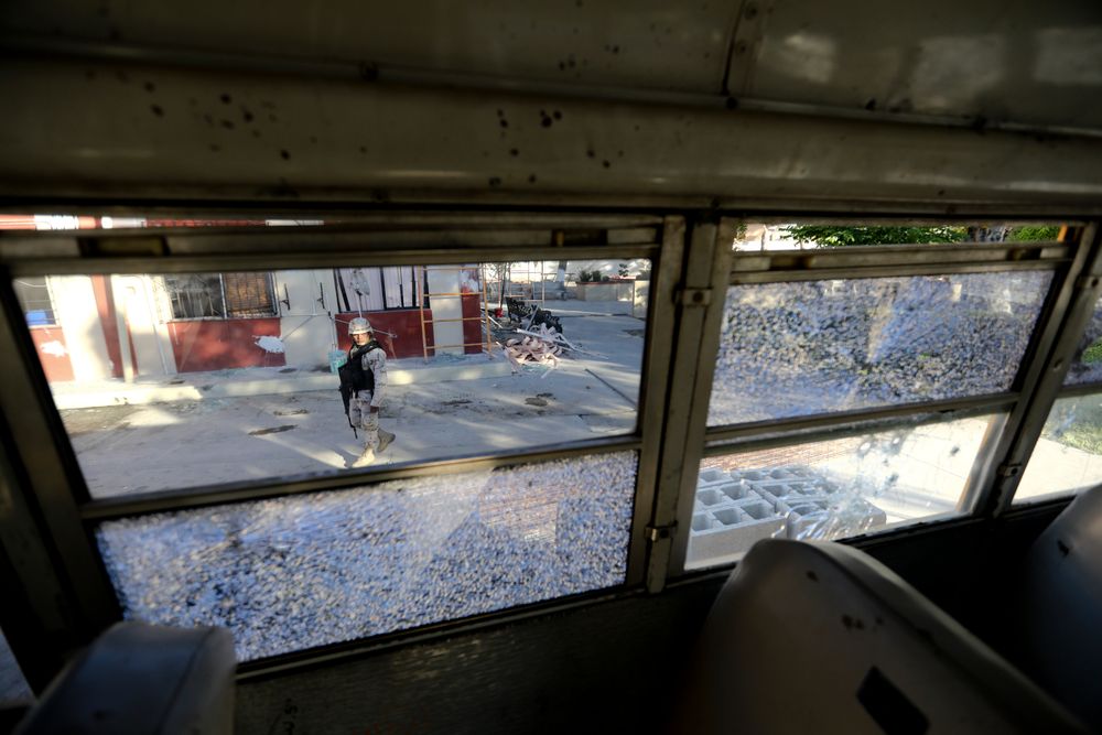 A soldier walks past City Hall that is riddled with bullet holes after a weekend gun battle, in Villa Union, Mexico, Tuesday, Dec. 3, 2019. Villa Union residents said Tuesday they fear a return to the bad old days of 2010-2013. The small town is 12 miles (20 kilometers) from the town of Allende, the site of a 2011 massacre in which the Zetas killed at least 70 people. (AP Photo/Eduardo Verdugo) A soldier walks past City Hall that is riddled with bullet holes after a weekend gun battle, in Villa Union, Mexico, Tuesday, Dec. 3, 2019. Villa Union residents said Tuesday they fear a return to the bad old days of 2010-2013. The small town is 12 miles (20 kilometers) from the town of Allende, the site of a 2011 massacre in which the Zetas killed at least 70 people. (AP Photo/Eduardo Verdugo)