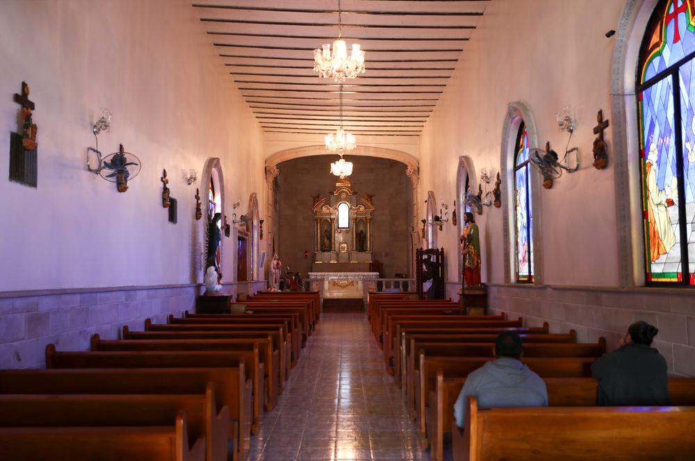People pray inside the church in Villa Union, Mexico, Tuesday, Dec. 3, 2019. Villa Union bears the scars of the hourslong gun battles Saturday and Sunday. The fight that unfolded between a cartel force estimated at 100 to 150 men and state police left 23 people dead. Many homes and buildings were riddled with bullet holes. (AP Photo/Eduardo Verdugo) People pray inside the church in Villa Union, Mexico, Tuesday, Dec. 3, 2019. Villa Union bears the scars of the hourslong gun battles Saturday and Sunday. The fight that unfolded between a cartel force estimated at 100 to 150 men and state police left 23 people dead. Many homes and buildings were riddled with bullet holes. (AP Photo/Eduardo Verdugo)