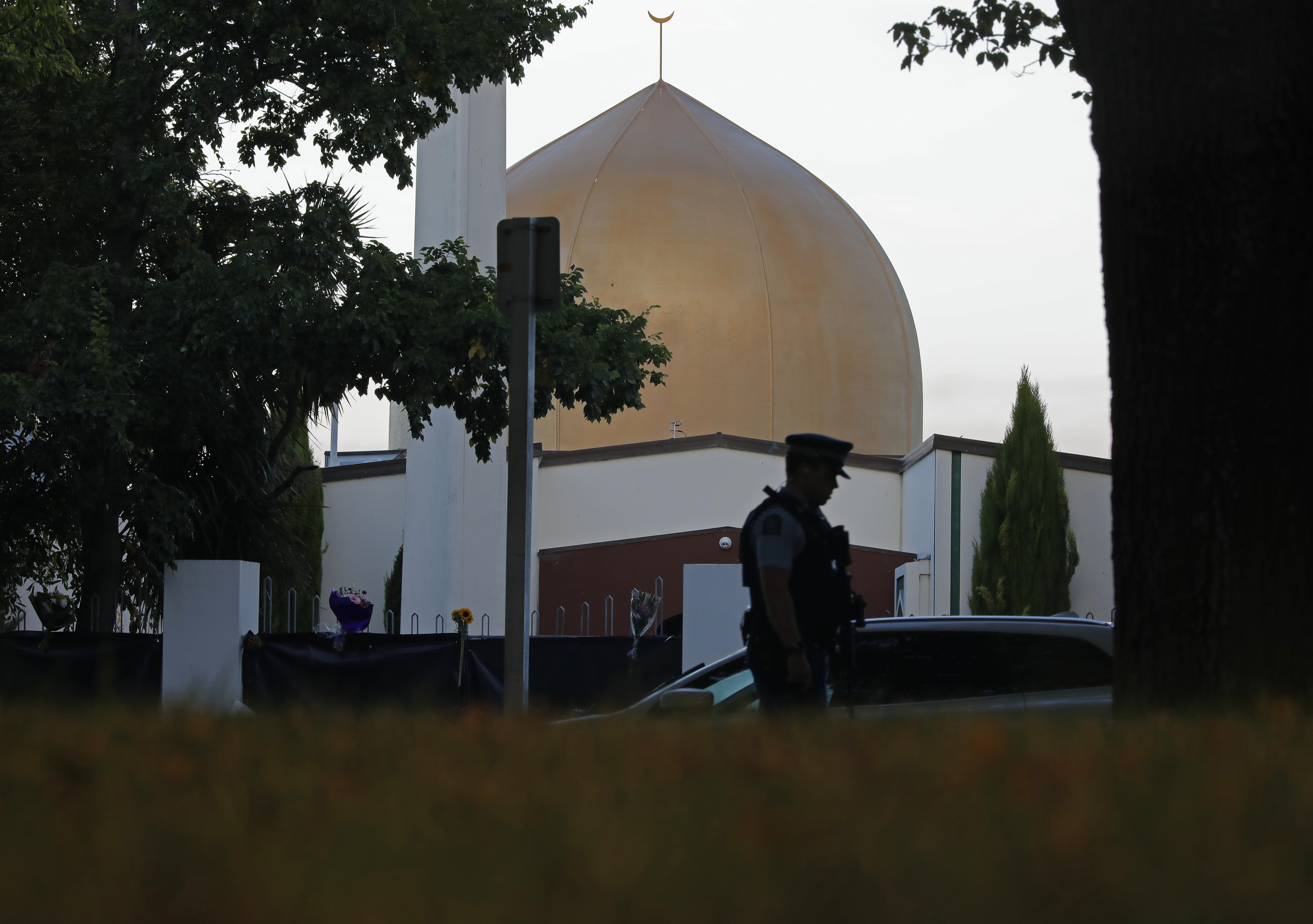 FILE - In this March 17, 2019, file photo, a police officer stands guard in front of the Al Noor mosque in Christchurch, New Zealand. On Friday, the imam, Gamal Fouda, had just finished the Khutbah, the formal sermon that’s delivered in Arabic, and he had started the next part in which he translated it into English. As the gunman approached the mosque, a man in the entrance called out cheerfully, “Hello, brother.” Brenton Tarrant fired several shots, one after another, and walked past the first bodies.(AP Photo/Vincent Yu, File) FILE - In this March 17, 2019, file photo, a police officer stands guard in front of the Al Noor mosque in Christchurch, New Zealand. On Friday, the imam, Gamal Fouda, had just finished the Khutbah, the formal sermon that’s delivered in Arabic, and he had started the next part in which he translated it into English. As the gunman approached the mosque, a man in the entrance called out cheerfully, “Hello, brother.” Brenton Tarrant fired several shots, one after another, and walked past the first bodies.(AP Photo/Vincent Yu, File)