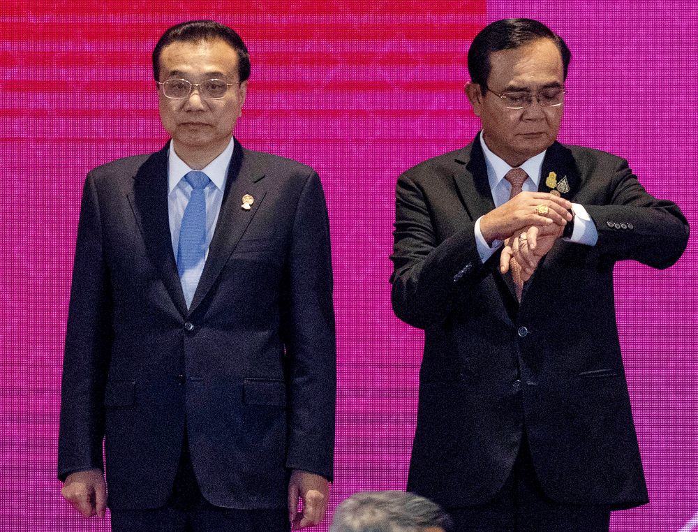 Thailand Prime Minister Prayuth Chan-ocha, right, looks at his watch as Chinese Premier Li Keqiang stands beside him for a group photo at East Asia Summit on the sidelines of the 35th Association of Southeast Asian Nations (ASEAN) summit in Nonthaburi, Thailand, Monday, Nov. 4, 2019. (AP Photo/Wason Wanichakorn) Thailand Prime Minister Prayuth Chan-ocha, right, looks at his watch as Chinese Premier Li Keqiang stands beside him for a group photo at East Asia Summit on the sidelines of the 35th Association of Southeast Asian Nations (ASEAN) summit in Nonthaburi, Thailand, Monday, Nov. 4, 2019. (AP Photo/Wason Wanichakorn)