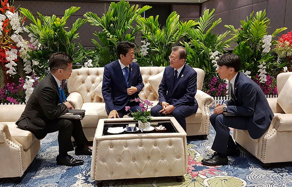 In this photo provided by South Korea Presidential Blue House, South Korean President Moon Jae-in, center right, talks with Japanese Prime Minister Shinzo Abe, center left, ahead of the ASEAN+3 Summit in Nonthaburi, Thailand, Monday, Nov. 4, 2019. (South Korea Presidential Blue House via AP) In this photo provided by South Korea Presidential Blue House, South Korean President Moon Jae-in, center right, talks with Japanese Prime Minister Shinzo Abe, center left, ahead of the ASEAN+3 Summit in Nonthaburi, Thailand, Monday, Nov. 4, 2019. (South Korea Presidential Blue House via AP)