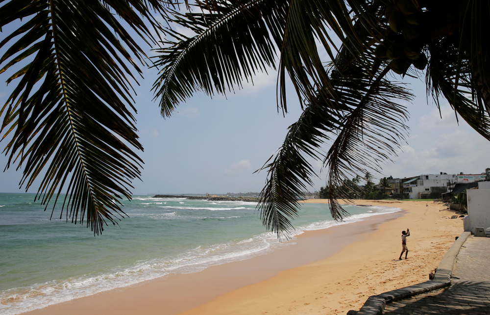 In this Friday, May 10, 2019, photo, a boy walks on a beach in Hikkaduwa, Sri Lanka. Sri Lanka was the Lonely Planet guide’s top travel destination for 2019, but since the Easter Sunday attacks on churches and luxury hotels, foreign tourists have fled. Hikkaduwa, in the south west, used to be top tourist attraction for the strong waves that were perfect for board-surfing and sparkling clear waters perfect for snorkeling. Today, of the 27 hotels, a very few are still open while most of others along with the eateries lining the six kilometer stretch of palm-fringed beach, are closed. (AP Photo/Eranga Jayawardena) In this Friday, May 10, 2019, photo, a boy walks on a beach in Hikkaduwa, Sri Lanka. Sri Lanka was the Lonely Planet guide’s top travel destination for 2019, but since the Easter Sunday attacks on churches and luxury hotels, foreign tourists have fled. Hikkaduwa, in the south west, used to be top tourist attraction for the strong waves that were perfect for board-surfing and sparkling clear waters perfect for snorkeling. Today, of the 27 hotels, a very few are still open while most of others along with the eateries lining the six kilometer stretch of palm-fringed beach, are closed. (AP Photo/Eranga Jayawardena)