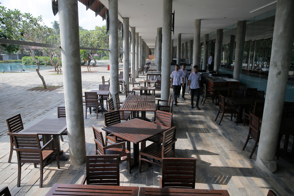 In this Friday, May 10, 2019, photo, hotel staff walk past an empty restaurant at a hotel in Hikkaduwa, Sri Lanka. Sri Lanka was the Lonely Planet guide’s top travel destination for 2019, but since the Easter Sunday attacks on churches and luxury hotels, foreign tourists have fled. Hikkaduwa, in the south west, used to be top tourist attraction for the strong waves that were perfect for board-surfing and sparkling clear waters perfect for snorkeling. Today, of the 27 hotels, a very few are still open while most of others along with the eateries lining the six kilometer stretch of palm-fringed beach, are closed. (AP Photo/Eranga Jayawardena) In this Friday, May 10, 2019, photo, hotel staff walk past an empty restaurant at a hotel in Hikkaduwa, Sri Lanka. Sri Lanka was the Lonely Planet guide’s top travel destination for 2019, but since the Easter Sunday attacks on churches and luxury hotels, foreign tourists have fled. Hikkaduwa, in the south west, used to be top tourist attraction for the strong waves that were perfect for board-surfing and sparkling clear waters perfect for snorkeling. Today, of the 27 hotels, a very few are still open while most of others along with the eateries lining the six kilometer stretch of palm-fringed beach, are closed. (AP Photo/Eranga Jayawardena)