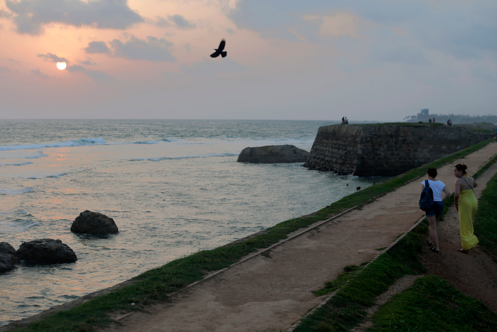 In this Friday, May 10, 2019, photo, foreign tourists walk on the rampart of the 17th century built Dutch fort in Galle, Sri Lanka. Sri Lanka was the Lonely Planet guide’s top travel destination for 2019, but since the Easter Sunday attacks on churches and luxury hotels, foreign tourists have fled. More than 250 people, including 45 foreigners who are mostly from China, India, the U.S. and the U.K., died in the series of suicide bombings by Islamic State and its local affiliates in churches and hotels in the capital, Colombo, and across the country on April 21. (AP Photo/Eranga Jayawardena) In this Friday, May 10, 2019, photo, foreign tourists walk on the rampart of the 17th century built Dutch fort in Galle, Sri Lanka. Sri Lanka was the Lonely Planet guide’s top travel destination for 2019, but since the Easter Sunday attacks on churches and luxury hotels, foreign tourists have fled. More than 250 people, including 45 foreigners who are mostly from China, India, the U.S. and the U.K., died in the series of suicide bombings by Islamic State and its local affiliates in churches and hotels in the capital, Colombo, and across the country on April 21. (AP Photo/Eranga Jayawardena)