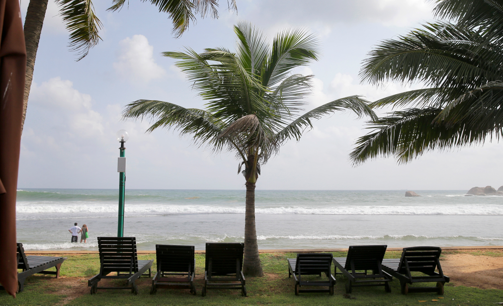 In this Friday, May 10, 2019, photo, lounge chairs lie on a deserted beach in Hikkaduwa, Sri Lanka. Sri Lanka was the Lonely Planet guide’s top travel destination for 2019, but since the Easter Sunday attacks on churches and luxury hotels, foreign tourists have fled. Hikkaduwa, in the south west, used to be top tourist attraction for the strong waves that were perfect for board-surfing and sparkling clear waters perfect for snorkeling. Today, of the 27 hotels, a very few are still open while most of others along with the eateries lining the six kilometer stretch of palm-fringed beach, are closed. (AP Photo/Eranga Jayawardena) In this Friday, May 10, 2019, photo, lounge chairs lie on a deserted beach in Hikkaduwa, Sri Lanka. Sri Lanka was the Lonely Planet guide’s top travel destination for 2019, but since the Easter Sunday attacks on churches and luxury hotels, foreign tourists have fled. Hikkaduwa, in the south west, used to be top tourist attraction for the strong waves that were perfect for board-surfing and sparkling clear waters perfect for snorkeling. Today, of the 27 hotels, a very few are still open while most of others along with the eateries lining the six kilometer stretch of palm-fringed beach, are closed. (AP Photo/Eranga Jayawardena)