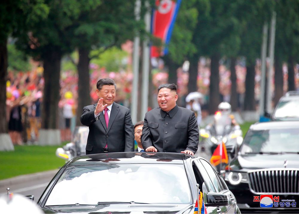 In this Thursday, June 20, 2019, photo provided by the North Korean government, North Korean leader Kim Jong Un, right, and Chinese President Xi Jinping acknowledge welcoming people from the limousine in Pyongyang, North Korea. The content of this image is as provided and cannot be independently verified. Korean language watermark on image as provided by source reads: In this Thursday, June 20, 2019, photo provided by the North Korean government, North Korean leader Kim Jong Un, right, and Chinese President Xi Jinping acknowledge welcoming people from the limousine in Pyongyang, North Korea. The content of this image is as provided and cannot be independently verified. Korean language watermark on image as provided by source reads: