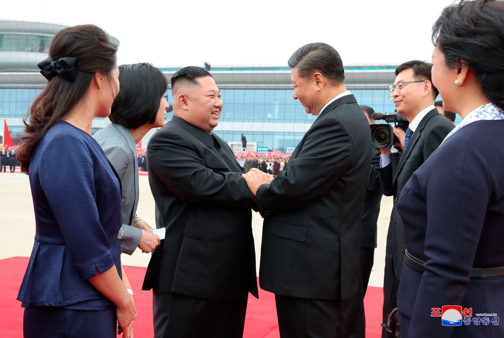 In this Thursday, June 20, 2019, photo provided by the North Korean government, North Korean leader Kim Jong Un, center left, shakes hands with Chinese President Xi Jinping at Pyongyang International Airport in Pyongyang, North Korea. The content of this image is as provided and cannot be independently verified. Korean language watermark on image as provided by source reads: In this Thursday, June 20, 2019, photo provided by the North Korean government, North Korean leader Kim Jong Un, center left, shakes hands with Chinese President Xi Jinping at Pyongyang International Airport in Pyongyang, North Korea. The content of this image is as provided and cannot be independently verified. Korean language watermark on image as provided by source reads: