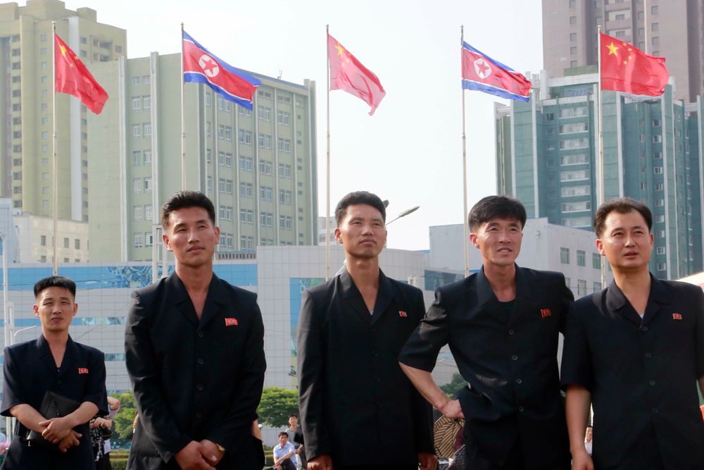 North Koreans watch a large screen reporting Chinese President Xi Jinping's visit in front of the both countries' national flags at Pyongyang Railway Station in Pyongyang, North Korea, Friday, June 21, 2019. Xi offered encouragement for North Korea’s focus on economic development in a speech in Pyongyang, turning to a topic Beijing has long pressed with its communist neighbor amid wider concerns over the North’s nuclear weapons program. (AP Photo/Jon Chol Jin) North Koreans watch a large screen reporting Chinese President Xi Jinping's visit in front of the both countries' national flags at Pyongyang Railway Station in Pyongyang, North Korea, Friday, June 21, 2019. Xi offered encouragement for North Korea’s focus on economic development in a speech in Pyongyang, turning to a topic Beijing has long pressed with its communist neighbor amid wider concerns over the North’s nuclear weapons program. (AP Photo/Jon Chol Jin)