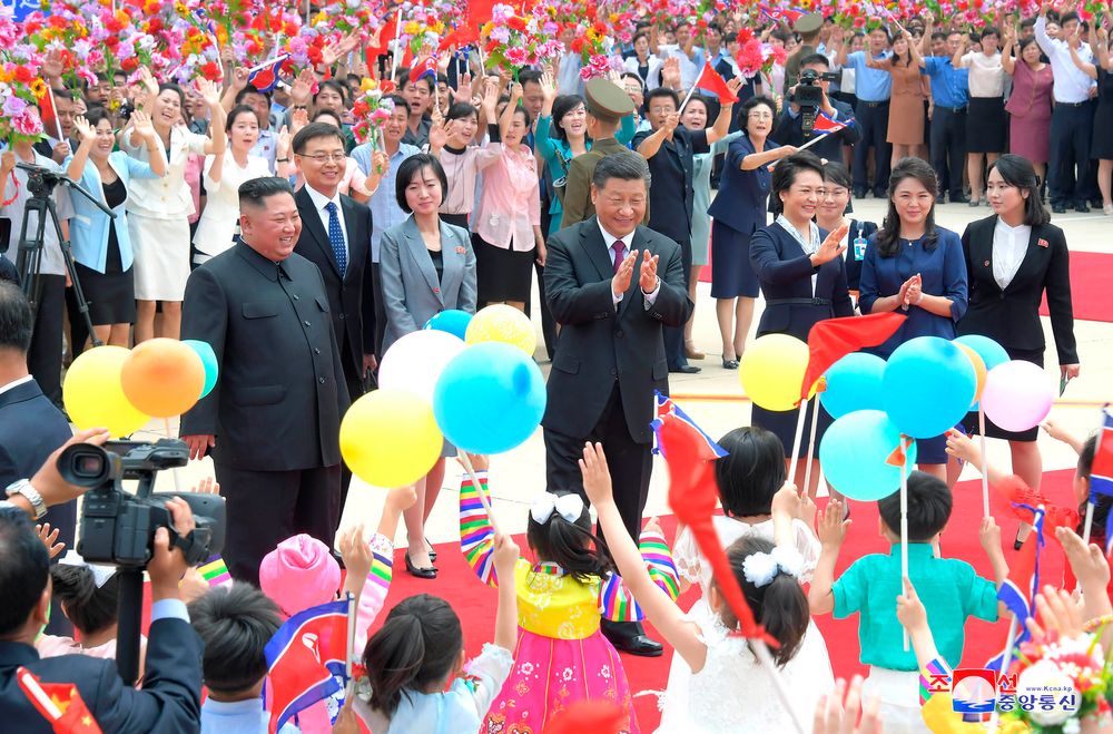 In this Thursday, June 20, 2019, photo provided by the North Korean government, Chinese President Xi Jinping, center, is welcomed by North Koran children at Pyongyang International Airport in Pyongyang, North Korea. North Korean leader Kim Jong Un, left, his wife Ri Sol Ju, second right, and Xi's wife Peng Liyuan, fourth right, also attended a welcoming ceremony. The content of this image is as provided and cannot be independently verified. Korean language watermark on image as provided by source reads: In this Thursday, June 20, 2019, photo provided by the North Korean government, Chinese President Xi Jinping, center, is welcomed by North Koran children at Pyongyang International Airport in Pyongyang, North Korea. North Korean leader Kim Jong Un, left, his wife Ri Sol Ju, second right, and Xi's wife Peng Liyuan, fourth right, also attended a welcoming ceremony. The content of this image is as provided and cannot be independently verified. Korean language watermark on image as provided by source reads: