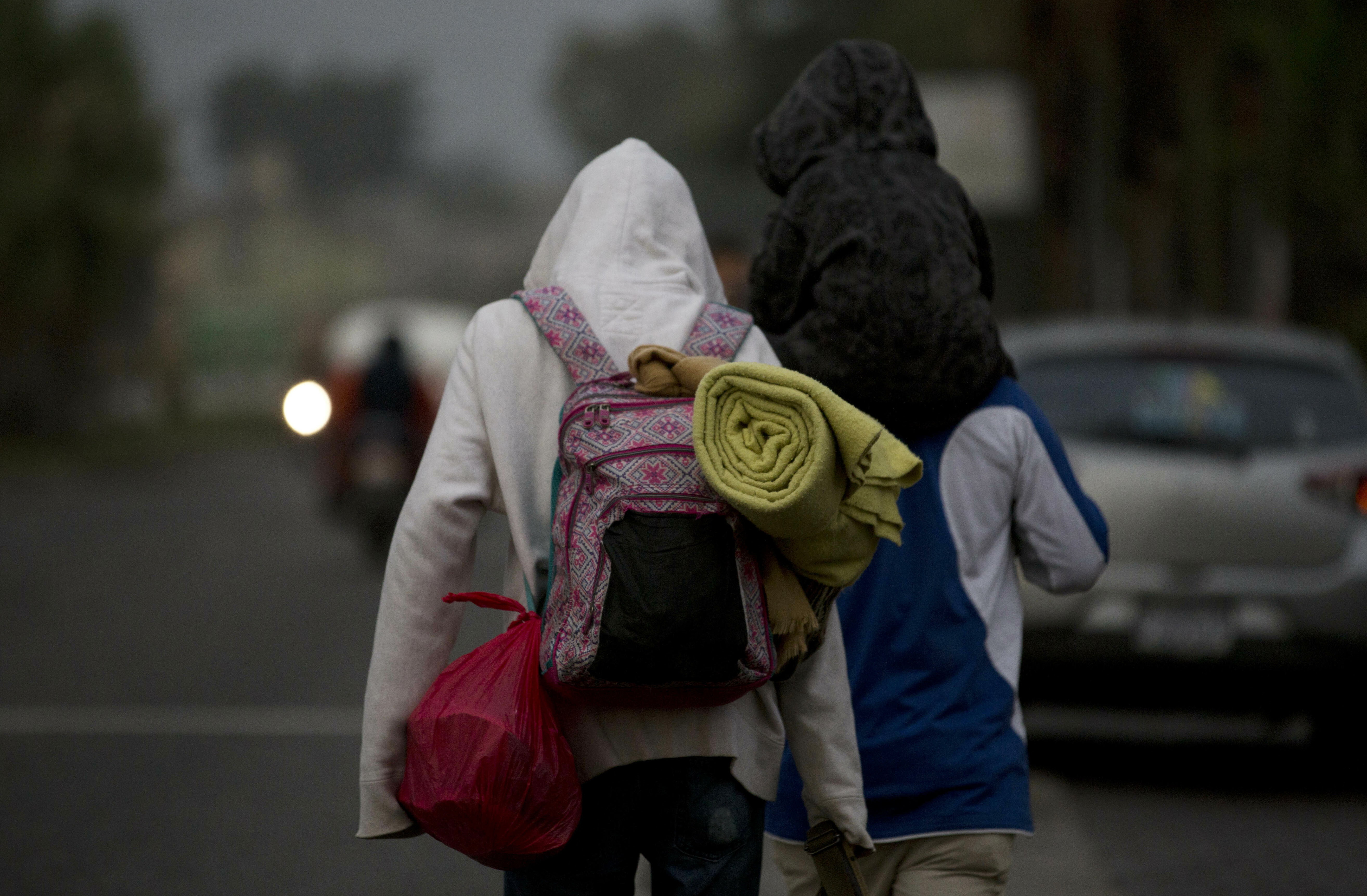 Honduran migrants carry their belongings on their backs as they walk at dawn along the roadside through Esquipulas, Guatemala, as they make their way toward the U.S. border, Wednesday, Jan. 16, 2019. The latest caravan of Honduran migrants hoping to reach the U.S. has crossed into Guatemala. (AP Photo/Moises Castillo) Honduran migrants carry their belongings on their backs as they walk at dawn along the roadside through Esquipulas, Guatemala, as they make their way toward the U.S. border, Wednesday, Jan. 16, 2019. The latest caravan of Honduran migrants hoping to reach the U.S. has crossed into Guatemala. (AP Photo/Moises Castillo)