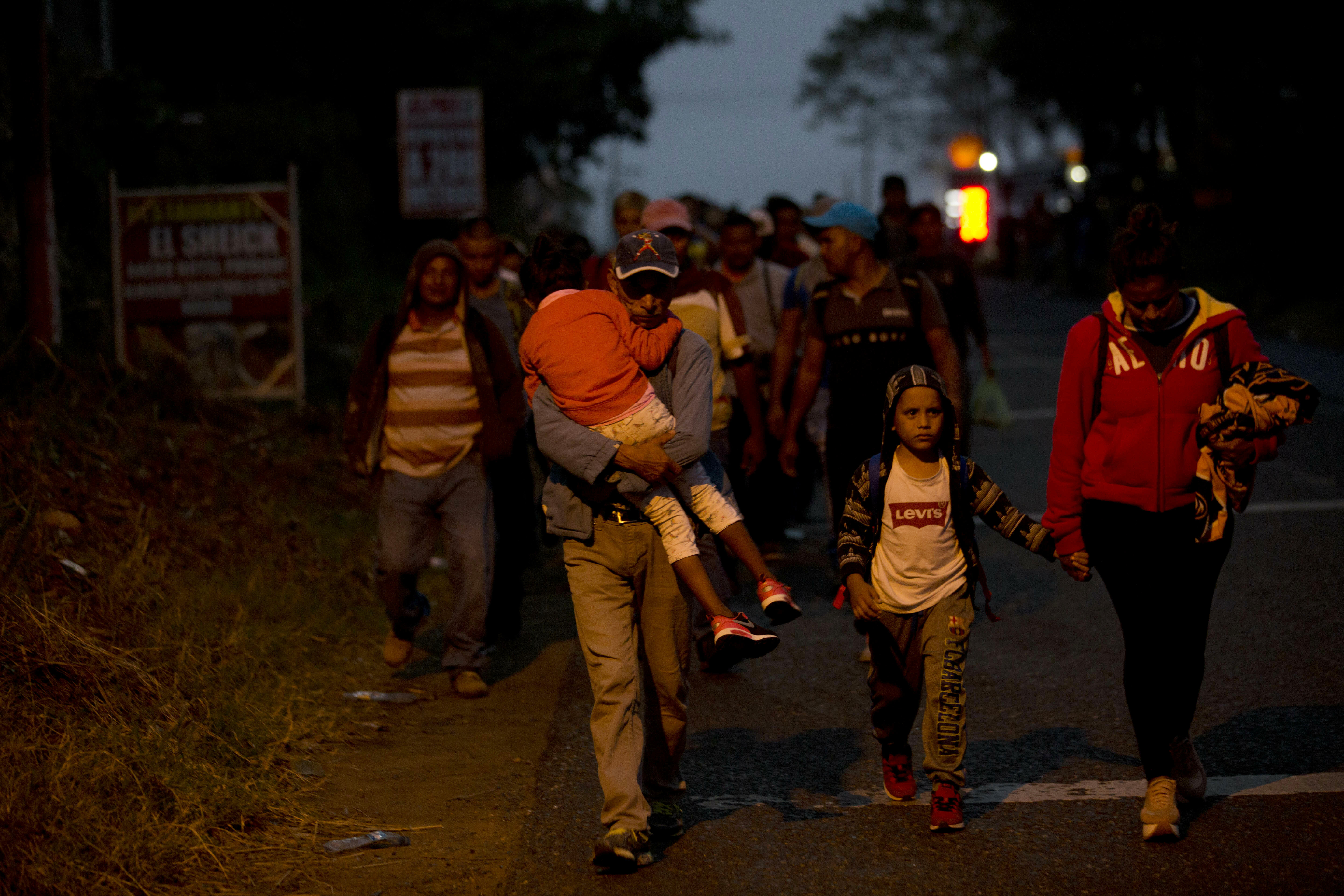 Honduran migrants walk at dawn along the roadside through Esquipulas, Guatemala, as they make their way toward the U.S. border, Wednesday, Jan. 16, 2019. The latest caravan of Honduran migrants hoping to reach the U.S. has crossed into Guatemala. (AP Photo/Moises Castillo) Honduran migrants walk at dawn along the roadside through Esquipulas, Guatemala, as they make their way toward the U.S. border, Wednesday, Jan. 16, 2019. The latest caravan of Honduran migrants hoping to reach the U.S. has crossed into Guatemala. (AP Photo/Moises Castillo)