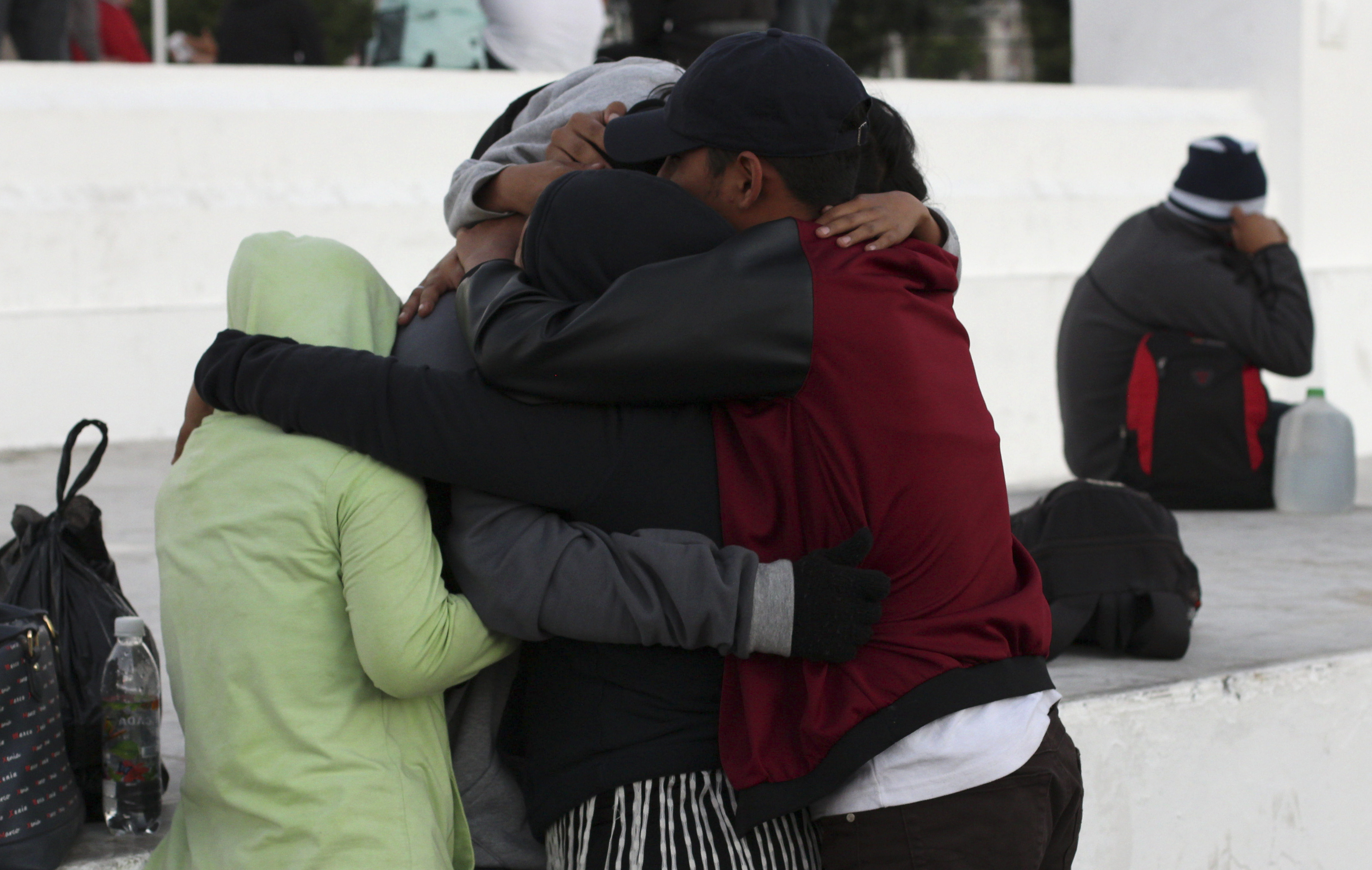 A man hugs his family before setting off toward the U.S. border with a migrant caravan from San Salvador, El Salvador, Wednesday, Jan. 16, 2019. Migrants fleeing Central America's Northern Triangle region comprising Honduras, El Salvador and Guatemala routinely cite poverty and rampant gang violence as their motivation for leaving. (AP Photo/Salvador Melendez) A man hugs his family before setting off toward the U.S. border with a migrant caravan from San Salvador, El Salvador, Wednesday, Jan. 16, 2019. Migrants fleeing Central America's Northern Triangle region comprising Honduras, El Salvador and Guatemala routinely cite poverty and rampant gang violence as their motivation for leaving. (AP Photo/Salvador Melendez)