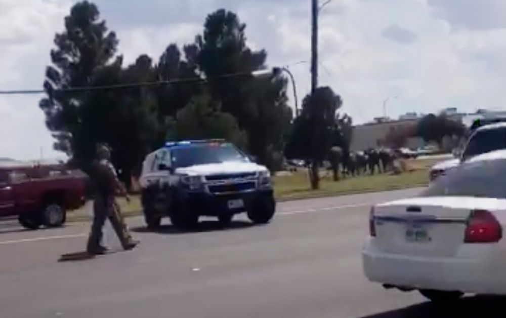 In this image made from video provided by Dustin Fawcett, police officers guard on a street in Odessa, Texas, Saturday, Aug. 31, 2019. Police said there are In this image made from video provided by Dustin Fawcett, police officers guard on a street in Odessa, Texas, Saturday, Aug. 31, 2019. Police said there are