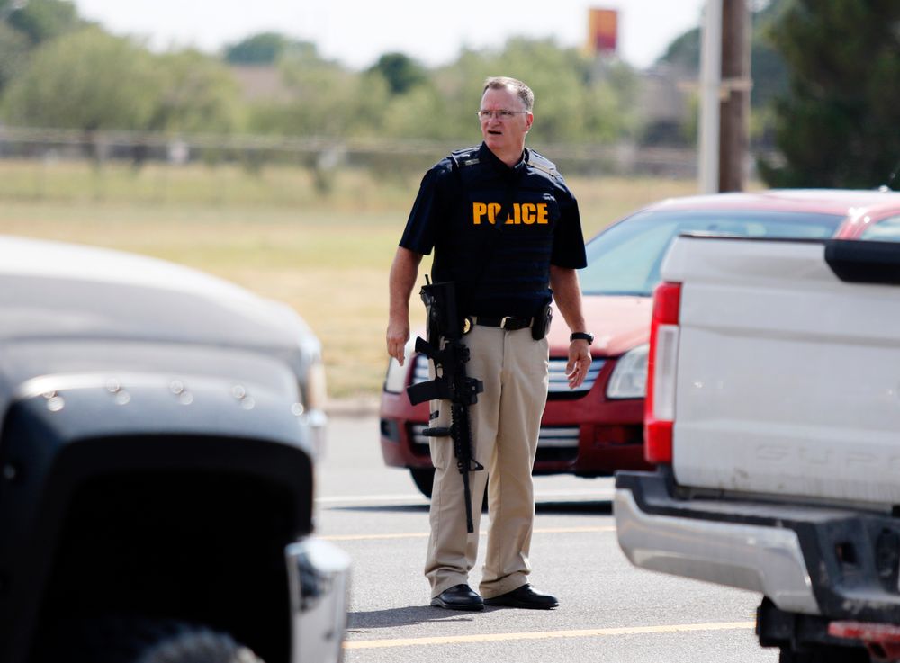 A law enforcement officer stands in the middle of the 5100 block of E. 42nd Street in Odessa, Texas, Saturday, Aug. 31, 2019, following a shooting at random in the area of Odessa and Midland. Several people were dead after a gunman who hijacked a postal service vehicle in West Texas shot more than 20 people, authorities said Saturday. The gunman was killed and a few law enforcement officers were among the injured. (Mark Rogers/Odessa American via AP) A law enforcement officer stands in the middle of the 5100 block of E. 42nd Street in Odessa, Texas, Saturday, Aug. 31, 2019, following a shooting at random in the area of Odessa and Midland. Several people were dead after a gunman who hijacked a postal service vehicle in West Texas shot more than 20 people, authorities said Saturday. The gunman was killed and a few law enforcement officers were among the injured. (Mark Rogers/Odessa American via AP)