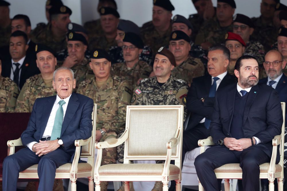 Lebanese Parliament Speaker Nabih Berri, left, and resigned Lebanese Prime Minister Saad Hariri attend a military parade to mark the 76th anniversary of Lebanon's independence from France at the Lebanese Defense Ministry, in Yarzeh near Beirut, Lebanon, Friday, Nov. 22, 2019. Lebanon's top politicians Friday attended a military parade on the country's 76th Independence Day, appearing for the first time since the government resigned amid nationwide protests now in their second month. (AP Photo/Hassan Ammar) Lebanese Parliament Speaker Nabih Berri, left, and resigned Lebanese Prime Minister Saad Hariri attend a military parade to mark the 76th anniversary of Lebanon's independence from France at the Lebanese Defense Ministry, in Yarzeh near Beirut, Lebanon, Friday, Nov. 22, 2019. Lebanon's top politicians Friday attended a military parade on the country's 76th Independence Day, appearing for the first time since the government resigned amid nationwide protests now in their second month. (AP Photo/Hassan Ammar)