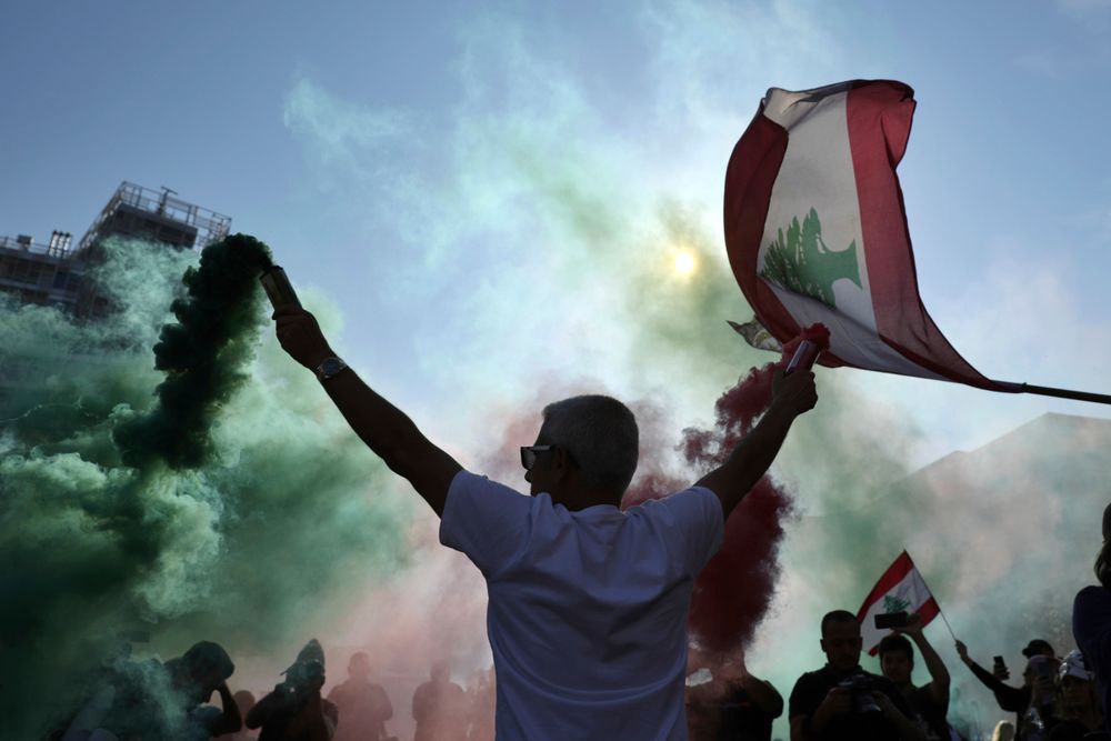 Anti-government protesters wave Lebanese national flags as they gather during a separate civil parade at the Martyr square, in downtown Beirut, Lebanon, Friday, Nov. 22, 2019. Protesters gathered for alternative independence celebrations, converging by early afternoon on Martyrs’ Square in central Beirut, which used to be the traditional location of the official parade. Protesters have occupied the area, closing it off to traffic since mid-October (AP Photo/Hassan Ammar) Anti-government protesters wave Lebanese national flags as they gather during a separate civil parade at the Martyr square, in downtown Beirut, Lebanon, Friday, Nov. 22, 2019. Protesters gathered for alternative independence celebrations, converging by early afternoon on Martyrs’ Square in central Beirut, which used to be the traditional location of the official parade. Protesters have occupied the area, closing it off to traffic since mid-October (AP Photo/Hassan Ammar)