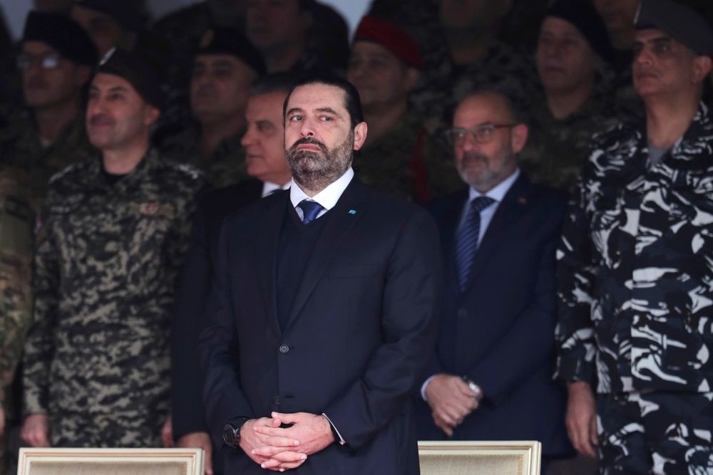 Former Prime Minister Saad Hariri attends a military parade to mark the 76th anniversary of Lebanon's independence from France at the Lebanese Defense Ministry, in Yarzeh near Beirut, Lebanon, Friday, Nov. 22, 2019. Lebanon's top politicians Friday attended a military parade on the country's 76th Independence Day, appearing for the first time since the government resigned amid nationwide protests now in their second month. (AP Photo/Hassan Ammar) Former Prime Minister Saad Hariri attends a military parade to mark the 76th anniversary of Lebanon's independence from France at the Lebanese Defense Ministry, in Yarzeh near Beirut, Lebanon, Friday, Nov. 22, 2019. Lebanon's top politicians Friday attended a military parade on the country's 76th Independence Day, appearing for the first time since the government resigned amid nationwide protests now in their second month. (AP Photo/Hassan Ammar)
