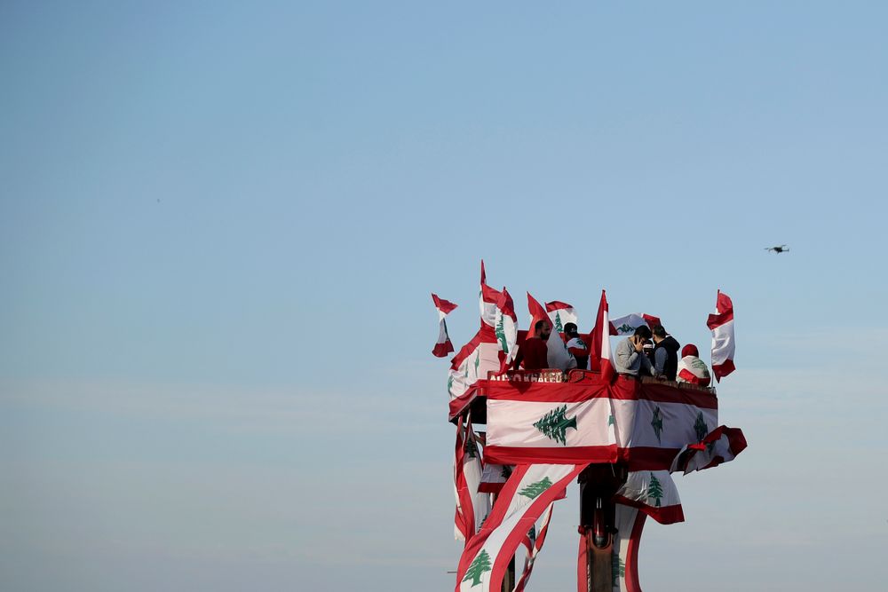 Anti-government protesters gather during separate civil parade at the Martyr square, in downtown Beirut, Lebanon, Friday, Nov. 22, 2019. Protesters gathered for their own alternative independence celebrations, converging by early afternoon on Martyrs' square in central Beirut, which used to be the traditional location for the official parade. Protesters have occupied the area, closing it off to traffic since mid-October. (AP Photo/Hassan Ammar) Anti-government protesters gather during separate civil parade at the Martyr square, in downtown Beirut, Lebanon, Friday, Nov. 22, 2019. Protesters gathered for their own alternative independence celebrations, converging by early afternoon on Martyrs' square in central Beirut, which used to be the traditional location for the official parade. Protesters have occupied the area, closing it off to traffic since mid-October. (AP Photo/Hassan Ammar)