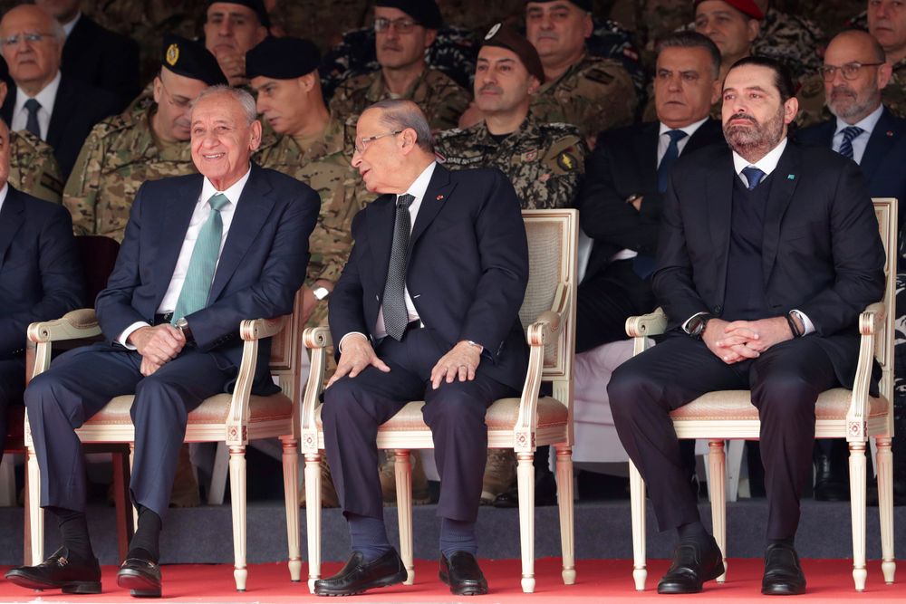 Lebanese President Michel Aoun, center, former Prime Minister Saad Hariri, right, and Lebanese Parliament Speaker Nabih Berri, left, attend a military parade to mark the 76th anniversary of Lebanon's independence from France at the Lebanese Defense Ministry, in Yarzeh near Beirut, Lebanon, Friday, Nov. 22, 2019. Lebanon's top politicians Friday attended a military parade on the country's 76th Independence Day, appearing for the first time since the government resigned amid nationwide protests now in their second month. (AP Photo/Hassan Ammar) Lebanese President Michel Aoun, center, former Prime Minister Saad Hariri, right, and Lebanese Parliament Speaker Nabih Berri, left, attend a military parade to mark the 76th anniversary of Lebanon's independence from France at the Lebanese Defense Ministry, in Yarzeh near Beirut, Lebanon, Friday, Nov. 22, 2019. Lebanon's top politicians Friday attended a military parade on the country's 76th Independence Day, appearing for the first time since the government resigned amid nationwide protests now in their second month. (AP Photo/Hassan Ammar)