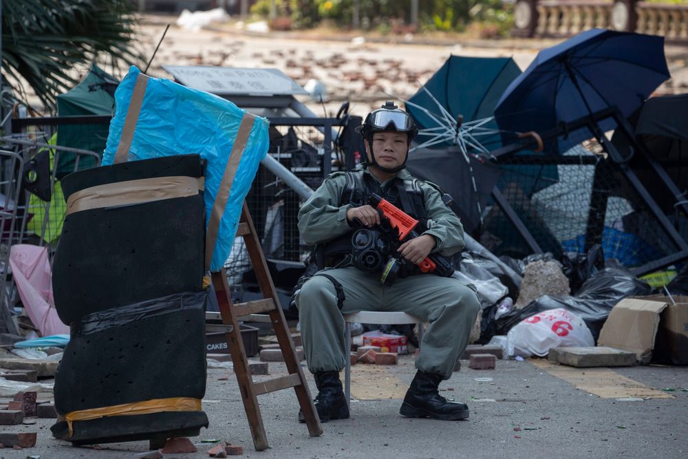 A police officer watches the Polytechnic University entrance in Hong Kong on Wednesday, Nov. 20, 2019. A small group of protesters refused to leave Hong Kong Polytechnic University, the remnants of hundreds who took over the campus for several days. They won't leave because they would face arrest. Police have set up a cordon around the area to prevent anyone from escaping. (AP Photo/Ng Han Guan) A police officer watches the Polytechnic University entrance in Hong Kong on Wednesday, Nov. 20, 2019. A small group of protesters refused to leave Hong Kong Polytechnic University, the remnants of hundreds who took over the campus for several days. They won't leave because they would face arrest. Police have set up a cordon around the area to prevent anyone from escaping. (AP Photo/Ng Han Guan)