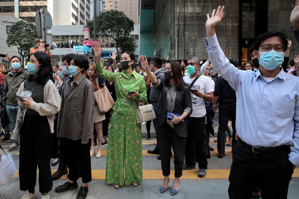 Protesters hold up their hands to symbolize pro-democracy demonstrators' five demands during a demonstration in the financial district in Hong Kong, Wednesday, Nov. 20, 2019. Hong Kong schools reopened Wednesday after a six-day shutdown but students and commuters faced transit disruptions as the last protesters remained holed up on a university campus. (AP Photo/Kin Cheung) Protesters hold up their hands to symbolize pro-democracy demonstrators' five demands during a demonstration in the financial district in Hong Kong, Wednesday, Nov. 20, 2019. Hong Kong schools reopened Wednesday after a six-day shutdown but students and commuters faced transit disruptions as the last protesters remained holed up on a university campus. (AP Photo/Kin Cheung)