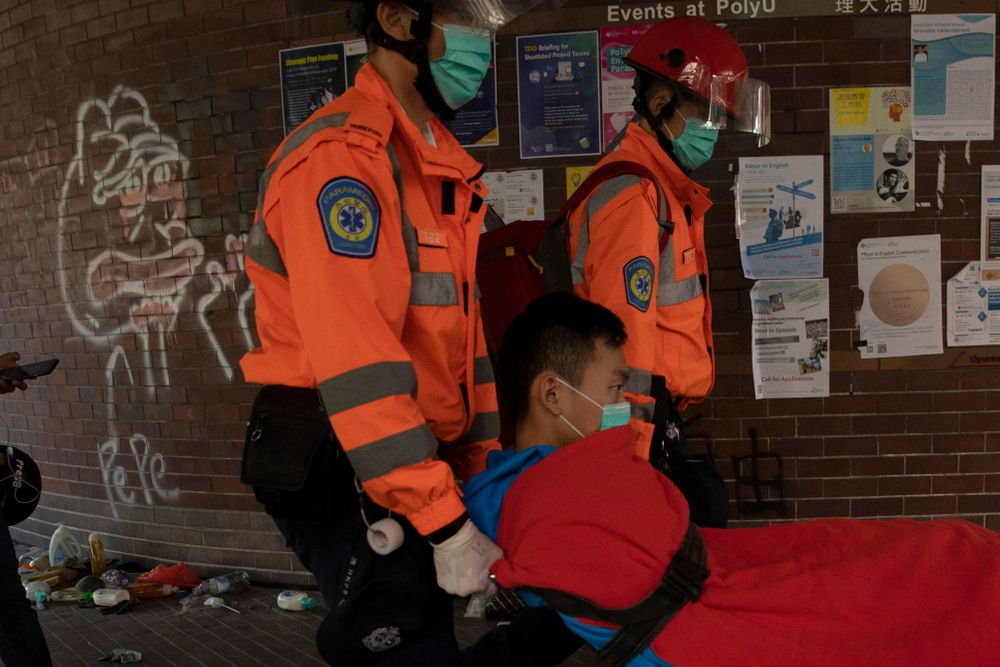 A man is evacuated by medics past graffiti of Pepe the Frog, which has been used a s symbol of the youth-led protest, from the Polytechnic University in Hong Kong on Wednesday, Nov. 20, 2019. Hong Kong schools have reopened after a six-day shutdown but students were facing transit disruptions as the last protesters remained holed up on a university campus. (AP Photo/Ng Han Guan) A man is evacuated by medics past graffiti of Pepe the Frog, which has been used a s symbol of the youth-led protest, from the Polytechnic University in Hong Kong on Wednesday, Nov. 20, 2019. Hong Kong schools have reopened after a six-day shutdown but students were facing transit disruptions as the last protesters remained holed up on a university campus. (AP Photo/Ng Han Guan)
