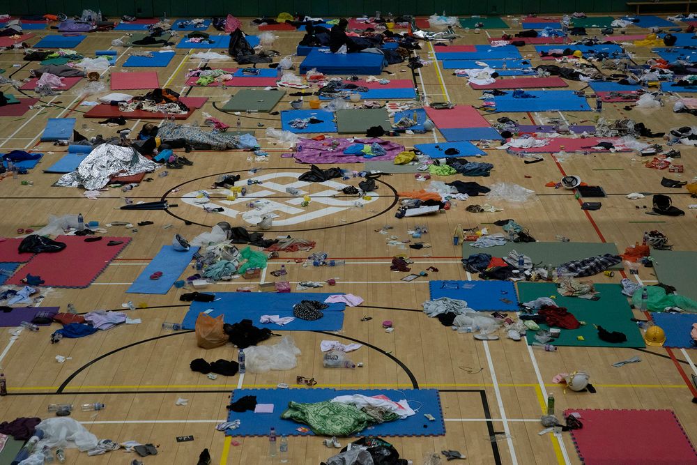 Protesters rest in a gymnasium on the campus of the Polytechnic University in Hong Kong on Wednesday, Nov. 20, 2019. A small group of protesters refused to leave Hong Kong Polytechnic University, the remnants of hundreds who took over the campus for several days. They won't leave because they would face arrest. Police have set up a cordon around the area to prevent anyone from escaping. (AP Photo/Ng Han Guan) Protesters rest in a gymnasium on the campus of the Polytechnic University in Hong Kong on Wednesday, Nov. 20, 2019. A small group of protesters refused to leave Hong Kong Polytechnic University, the remnants of hundreds who took over the campus for several days. They won't leave because they would face arrest. Police have set up a cordon around the area to prevent anyone from escaping. (AP Photo/Ng Han Guan)