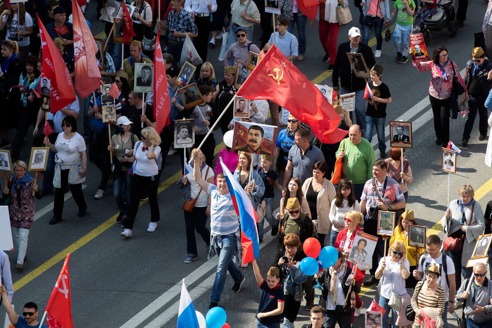 People carry portraits of relatives who fought in World War II, and Russian and Soviet flags, during the Immortal Regiment march through the main street toward Red Square celebrating 74 years since the victory in WWII in Red Square in Moscow, Russia, Thursday, May 9, 2019. (AP Photo/Denis Tyrin) People carry portraits of relatives who fought in World War II, and Russian and Soviet flags, during the Immortal Regiment march through the main street toward Red Square celebrating 74 years since the victory in WWII in Red Square in Moscow, Russia, Thursday, May 9, 2019. (AP Photo/Denis Tyrin)