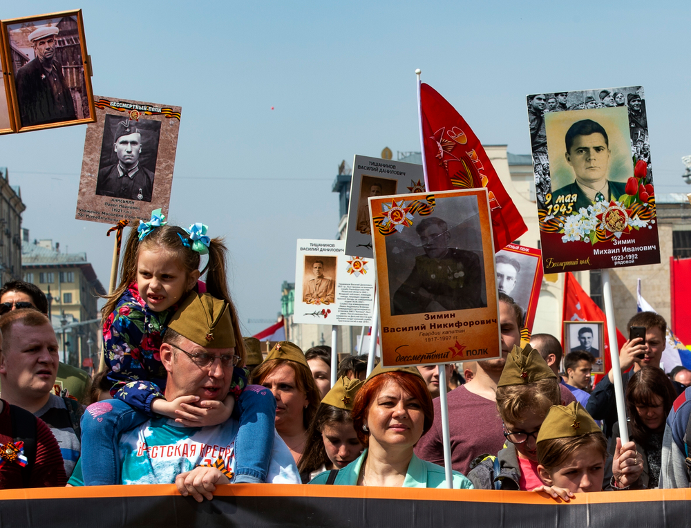People carry portraits of relatives who fought in World War II, and Soviet flags, during the Immortal Regiment march through the main street toward Red Square in Moscow, Russia, Thursday, May 9, 2019, celebrating 74 years since the end of WWII and the defeat of Nazi Germany. (AP Photo/Dmitry Serebryakov) People carry portraits of relatives who fought in World War II, and Soviet flags, during the Immortal Regiment march through the main street toward Red Square in Moscow, Russia, Thursday, May 9, 2019, celebrating 74 years since the end of WWII and the defeat of Nazi Germany. (AP Photo/Dmitry Serebryakov)